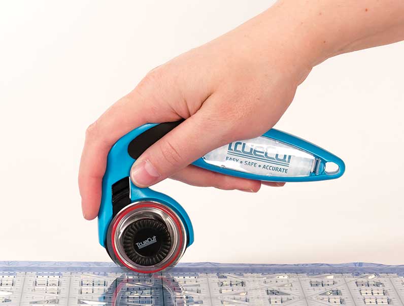 holding rotary cutter with finger