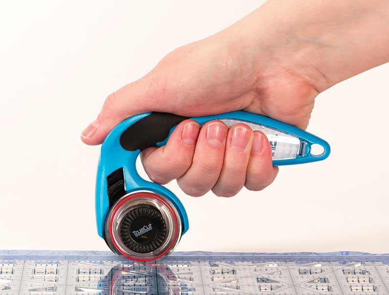 holding rotary cutter with thumb